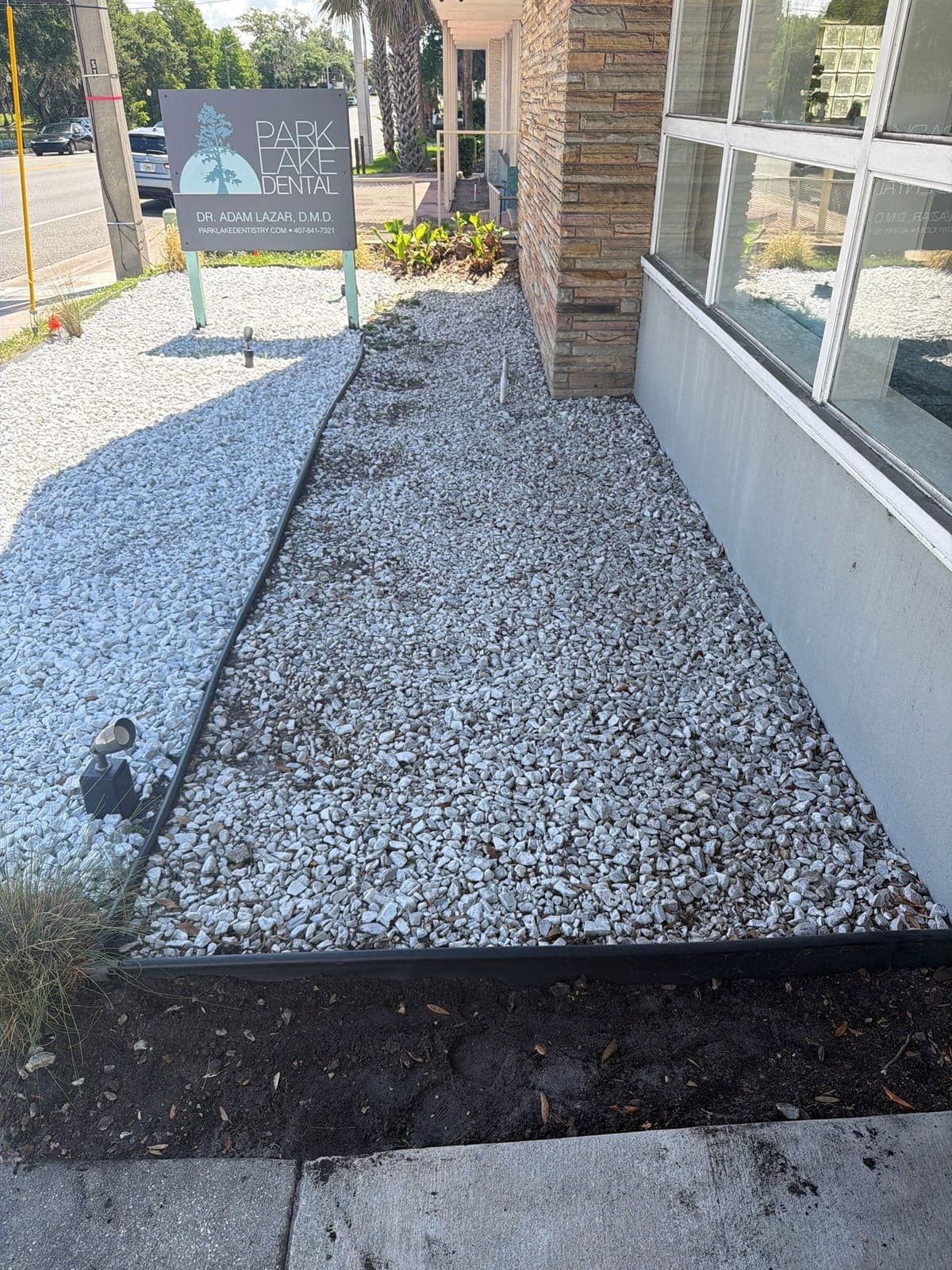 Commercial dental practice frontage with new gravel bed and landscaping in Orlando, FL — Firsthand Lawn and Landscape