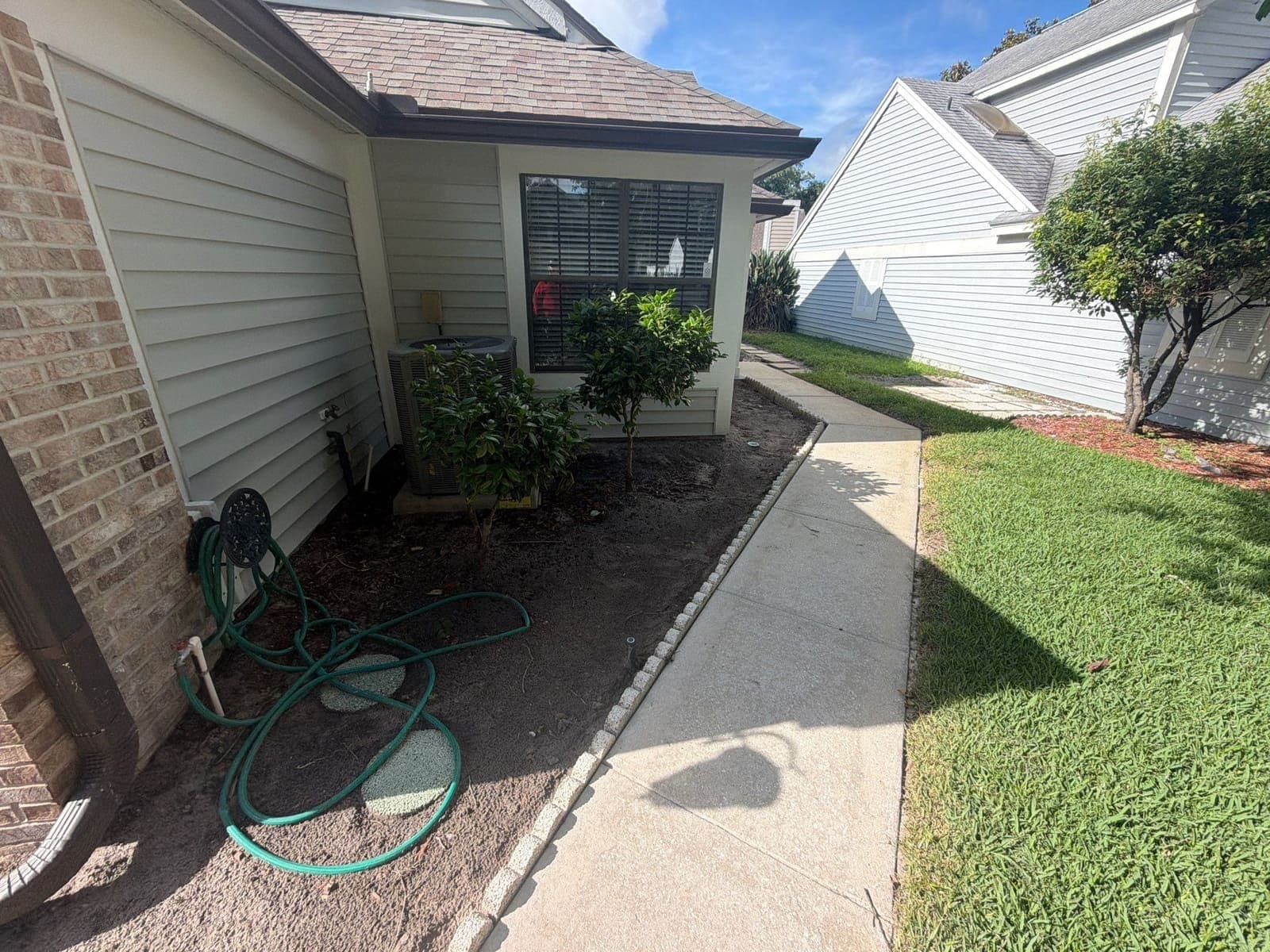 Fresh mulch installation along a Central Florida residential planting bed — Firsthand Lawn and Landscape