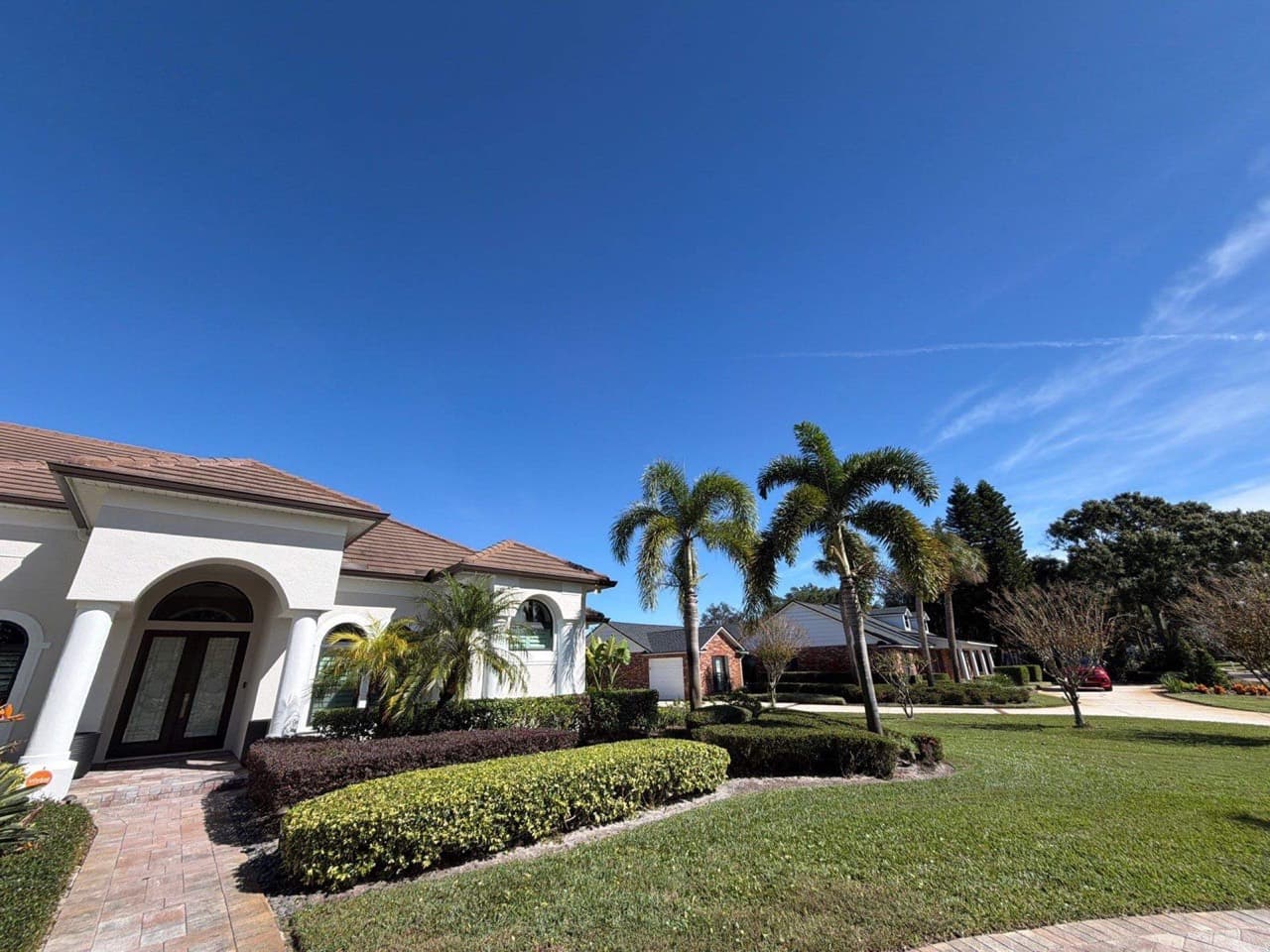 White Mediterranean estate with palms and fresh sod in Central Florida — Firsthand Lawn and Landscape